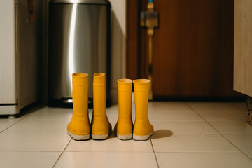 Close-up of two pairs of yellow children's wellies