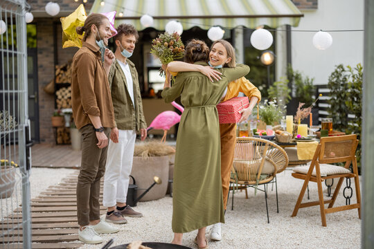 Young Adult Friends Gathering For Birthday Party At Backyard Of The House Outdoors. Happy To Greet And Embrace Each Other After The Pandemic