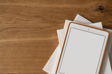 Blank screen display on wooden table. Flat lay, top view minimalist blog, website, app template. Copy space mockup.