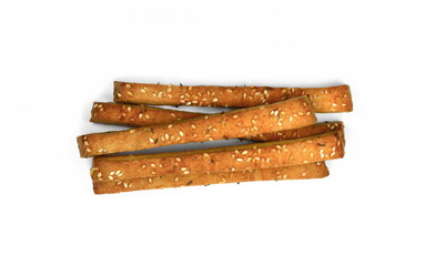 Homemade cheese sticks with cumin and sesame seeds. Bread sticks isolated on whute background. Baked salty sticks with salt and cumin. Golden baked savory pastry. Home baking appetizers. 