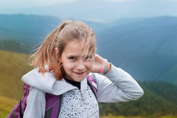 The young girl is delighted with the beauty of the mountains, where she now rests with her parents and is filled with freedom and the power of nature