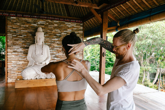 Teacher Helping Student in Postural Alignment Class