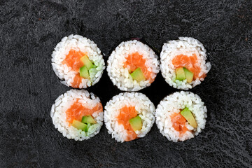 Sake maki Japanese roll with Salmon and avocado on stone. Saki sushi-roll, top view © Andrey