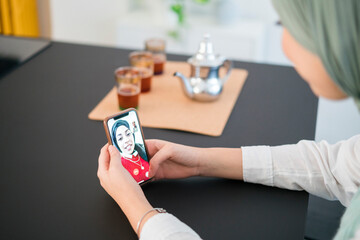 Arab sisters talking on video chat on smartphone