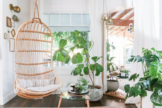 eclectic bohemian living room with indoor rattan swing