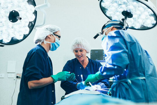 Surgeon and two nurses with patient in operarating theater