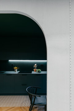 Interior of modern kitchen behind arch