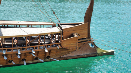 Athenian Trireme masterpiece replica "OLYMPIAS"of ancient warship of 5th BC century, moored at port and Marina of Zea next to busy port of Piraeus, Attica, Greece