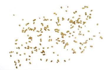 Gold sprinkles isolated on white background top view. Sweet brown glaze decoration or chocolate...