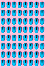A lot of identical turquoise computer mice with a black wheel, arranged vertically on a pink...