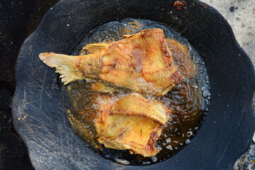 fried pieces of carp fish in a pan.