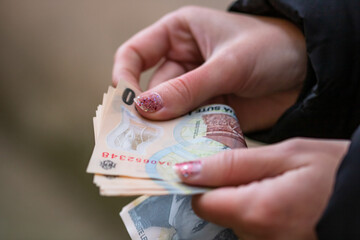 Selective focus on detail of LEI banknotes. Counting or giving Romanian LEI banknotes. World money concept, inflation and economy concept
