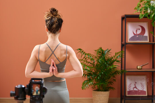 Yoga teacher performing asana for camera