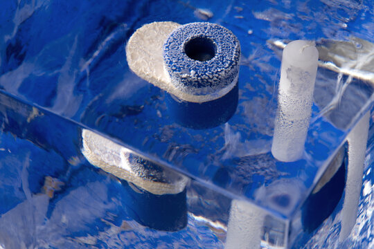 Big ice cube with frozen objects inside