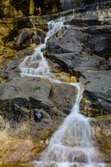 Obraz premium Beautiful waterfall on small river in a park