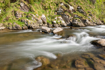 Long exposure of the River Heddon flowing into Heddons Mouth on the north Devon coast