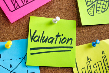 Valuation word on the green sticker pinned to the desk.