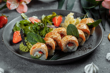Maki Sushi - a roll of cream cheese, strawberries, avocado and fried salmon. Summer seasonal sushi rolls