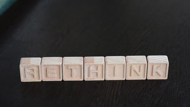 Female hands change first letter in word bethink so that it turns to rethink. Concept