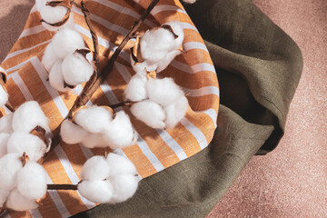 Serving napkins and a branch of cotton on a beige background