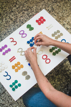 Artist arranging her hand made jewelry
