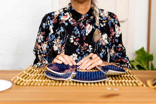 Portrait of hoary woman repairing a broken plate with a millenial japanese technique 