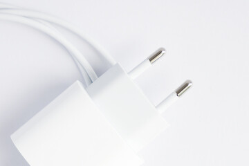 Top view of black phone AC charger and USB cable on white background