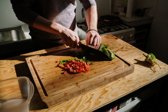 Man choping vegetables in kitchen