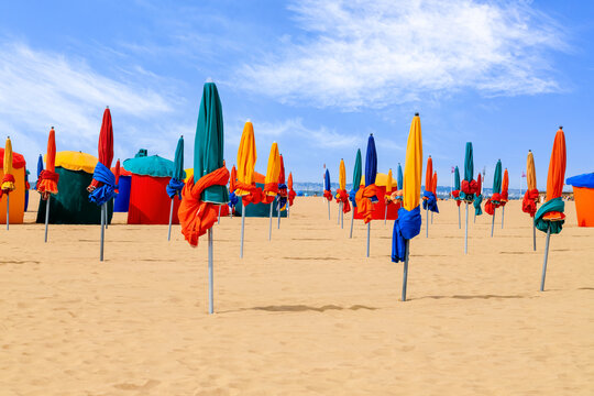 Colourful parasols, landmark of Deauville Beach, famous resort in Normandy, Northern France. Summer holidays.