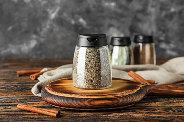 Jars with different spices on table