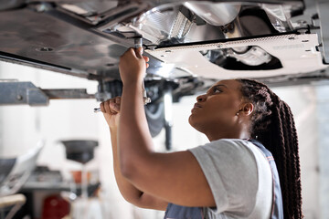 Afro auto mechanic work in garage, car service technician woman in overalls check and repair...