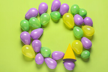 Frame made of air balloons on color background