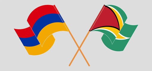 Crossed and waving flags of Armenia and Guyana