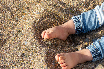 Close up of baby feet on the beach.