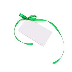 Blank sheet of paper with green ribbon and bow on white background