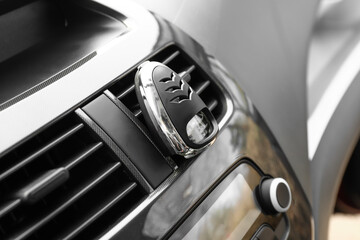 Air freshener hanging in car, closeup