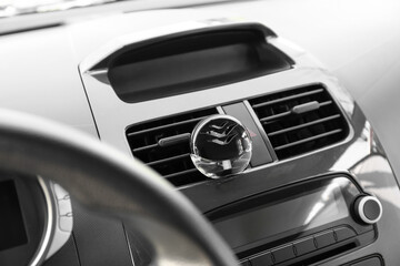 Fototapeta premium Air freshener hanging in car, closeup