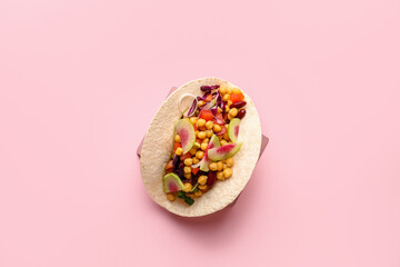 Obraz na płótnie Canvas Stand with tasty vegetarian taco on color background