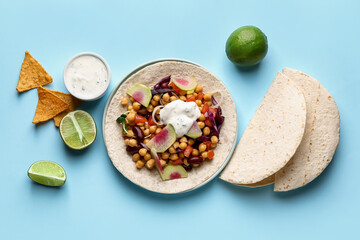 Plate with tasty vegetarian taco and sauce on color background