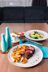 Sliced medium rare grilled Steak Ribeye with french fries