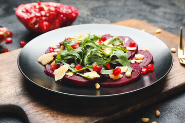 Plate with delicious beetroot carpaccio on dark background