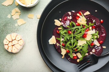Plate with delicious beetroot carpaccio on color background, closeup