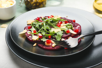 Plate with delicious beetroot carpaccio on table