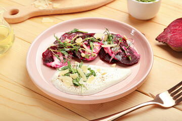 Plate with delicious beetroot carpaccio on wooden background