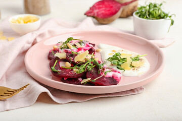 Plate with delicious beetroot carpaccio on light background