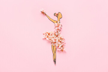 Paper ballerina figure with beautiful fruit tree flowers on color background © Pixel-Shot