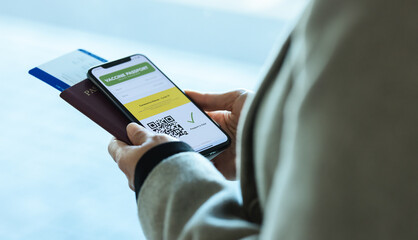 Woman traveling during pandemic using vaccination passport