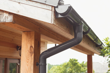 Polymer storm drainage system with a gutter on the roof of a private building