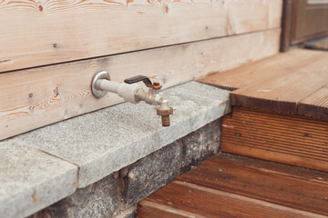 Watering tap on the house wall