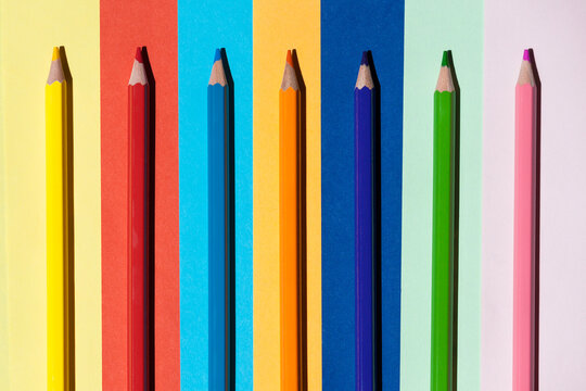 Color pencils on colored background. Back to school, arrangement concept.